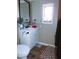 Bathroom featuring laminate flooring, a white vanity, toilet, and a dark framed mirror at 15625 N 25Th St # 21, Phoenix, AZ 85032