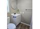 Modern bathroom features a white vanity, framed round mirror, and wood-look flooring at 15625 N 25Th St # 21, Phoenix, AZ 85032