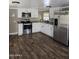 The kitchen features white cabinets, stainless steel appliances, and wood-look floors at 15625 N 25Th St # 21, Phoenix, AZ 85032