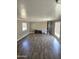 Spacious living room with wood-look floors and lots of natural light from a window at 15625 N 25Th St # 21, Phoenix, AZ 85032