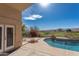 Serene backyard oasis with a pool, patio, and scenic golf course views under a sunny sky at 15644 S 13Th Pl, Phoenix, AZ 85048