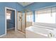 Bathroom with bathtub and glass shower stall, and bright blue walls at 15644 S 13Th Pl, Phoenix, AZ 85048