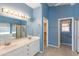 Bathroom with double sink vanity, bathtub, shower stall, and walk-in closet at 15644 S 13Th Pl, Phoenix, AZ 85048