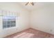 Bedroom featuring natural light with a large window, ceiling fan and neutral wall colors at 15644 S 13Th Pl, Phoenix, AZ 85048