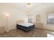 Neutral bedroom with tile floor features a ceiling fan and a lamp at 15644 S 13Th Pl, Phoenix, AZ 85048