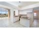 Open concept kitchen with breakfast bar, white cabinets, and stainless steel appliances overlooking the pool at 15644 S 13Th Pl, Phoenix, AZ 85048