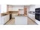 Traditional kitchen featuring white cabinets, granite countertops, and center island cooktop at 15644 S 13Th Pl, Phoenix, AZ 85048