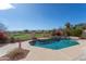 Sparkling pool with beautiful views of the community golf course and bright blue skies at 15644 S 13Th Pl, Phoenix, AZ 85048