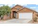 Close up exterior view of home showing the front door, house number, and garage at 1619 E Silverbirch Ave, Buckeye, AZ 85326