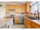 Kitchen featuring wood cabinets, stainless steel appliances, and tile flooring at 1619 E Silverbirch Ave, Buckeye, AZ 85326