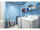 Functional laundry room with modern washer and dryer units at 1619 E Silverbirch Ave, Buckeye, AZ 85326