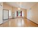 Open living area featuring wood floors, large window, and hanging light fixture at 1619 E Silverbirch Ave, Buckeye, AZ 85326