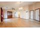 Spacious living room with wood floors, ceiling fan, and lots of natural light at 1619 E Silverbirch Ave, Buckeye, AZ 85326