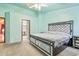 Spacious main bedroom with a decorative bed frame, ceiling fan, and ensuite bathroom at 1619 E Silverbirch Ave, Buckeye, AZ 85326