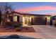 Charming single-story home featuring stone accents, a covered entryway, and a well-manicured front yard with desert landscaping at 16278 W Jenan Dr, Surprise, AZ 85379