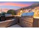 A stainless steel outdoor kitchen with granite countertops and ample storage for grilling and entertaining at 16278 W Jenan Dr, Surprise, AZ 85379