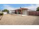 Low-maintenance backyard with covered patio, shed, and a fully fenced gravel area at 17258 N 66Th Dr, Glendale, AZ 85308