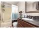 This bathroom features a bathtub with shower, a toilet, and vanity at 17258 N 66Th Dr, Glendale, AZ 85308