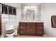 This bathroom features a dark wood vanity and toilet at 17258 N 66Th Dr, Glendale, AZ 85308