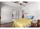 This bedroom features neutral walls, a ceiling fan and hardwood floors at 17258 N 66Th Dr, Glendale, AZ 85308