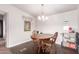 Bright dining area featuring hardwood floors and a modern chandelier with seating for four at 17258 N 66Th Dr, Glendale, AZ 85308