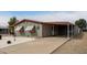 Charming single-story home with carport and simple landscaping of rocks and desert plants at 17258 N 66Th Dr, Glendale, AZ 85308