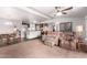 Cozy living room with a view of an open floorplan into dining area and kitchen at 17258 N 66Th Dr, Glendale, AZ 85308