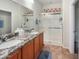 Bathroom featuring double sinks, granite countertops, and glass enclosed walk-in shower at 17542 W Pinnacle Vista Dr, Surprise, AZ 85387