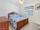 Cozy bedroom featuring a wooden bed frame, soft blue and white bedding, and a window with natural light at 17542 W Pinnacle Vista Dr, Surprise, AZ 85387