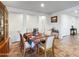 Bright dining room with tile floors, natural light, and a table set for six at 17542 W Pinnacle Vista Dr, Surprise, AZ 85387