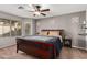 Cozy bedroom with a ceiling fan, large window, and stylish decor at 17634 W Hearn Rd, Surprise, AZ 85388