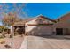 Charming single-story home featuring a two-car garage and desert landscaping with cacti and drought-tolerant plants at 17634 W Hearn Rd, Surprise, AZ 85388