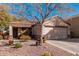 Charming single-story home featuring a two-car garage and desert landscaping with cacti and drought-tolerant plants at 17634 W Hearn Rd, Surprise, AZ 85388