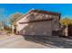 Single-story home with a two-car garage and desert landscaping at 17634 W Hearn Rd, Surprise, AZ 85388