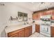 Functional kitchen with ample counter space, wooden cabinets, and bright lighting at 17634 W Hearn Rd, Surprise, AZ 85388