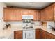 Bright kitchen with a range, ample cabinet space, and sleek countertops at 17634 W Hearn Rd, Surprise, AZ 85388