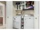 Convenient laundry room equipped with modern appliances and ample storage space at 17634 W Hearn Rd, Surprise, AZ 85388