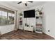 Bright living room with hardwood floors, a ceiling fan, and natural light at 17634 W Hearn Rd, Surprise, AZ 85388