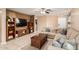 Comfortable living room featuring a sectional sofa, a ceiling fan, and a wooden coffee table at 17634 W Hearn Rd, Surprise, AZ 85388