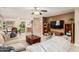 Inviting living room featuring a comfortable sofa, ceiling fan and an open view to the dining area at 17634 W Hearn Rd, Surprise, AZ 85388