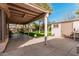 View of the covered patio and lush backyard featuring a storage shed at 17634 W Hearn Rd, Surprise, AZ 85388