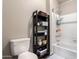 Bright bathroom with a toilet, shelving, and bathtub/shower combo at 1825 W Ray Rd # 2116, Chandler, AZ 85224