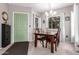 Cozy dining room with a wood table, chandelier lighting, and a striking green door at 1825 W Ray Rd # 2116, Chandler, AZ 85224