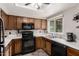 Classic kitchen featuring oak cabinets, modern black appliances, and neutral countertops at 1825 W Ray Rd # 2116, Chandler, AZ 85224