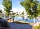 Beautiful community pond with grills and seating, surrounded by lush greenery and well-maintained residences at 1825 W Ray Rd # 2116, Chandler, AZ 85224