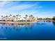 Aerial view of a serene lake with a water fountain and shopping center in the distance at 1825 W Ray Rd # 2116, Chandler, AZ 85224