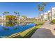 Picturesque view of a calm pond with palm trees and buildings reflected in the water at 1825 W Ray Rd # 2116, Chandler, AZ 85224