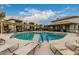 Community pool and spa with lounge chairs and a well-maintained deck at 1825 W Ray Rd # 2116, Chandler, AZ 85224