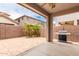 Private covered patio with brick surround, grill and low maintenance desert landscaping in the backyard at 19075 E Pelican Dr, Queen Creek, AZ 85142