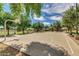 Community basketball court surrounded by green trees and blue sky at 19075 E Pelican Dr, Queen Creek, AZ 85142